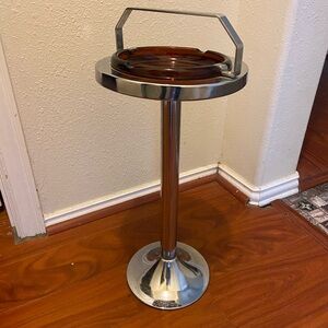 Vintage mid-century metal pedestal smoking stands with amber glass ashtray.
